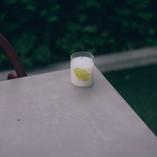 Load image into Gallery viewer, Small cute glass cup with a design of a tiny bird on top of a yellow blob background