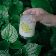 Load image into Gallery viewer, Small cute mini glass cup with a design of a tiny bird on top of a yellow blob background